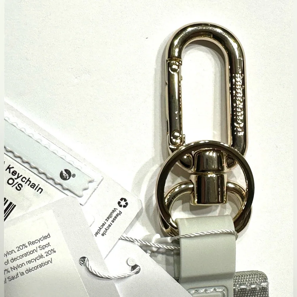 Lululemon Never Lost Keychain Wordmark Vapor Gold, NEW